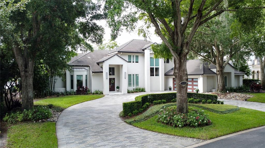 a front view of a house with a yard and trees