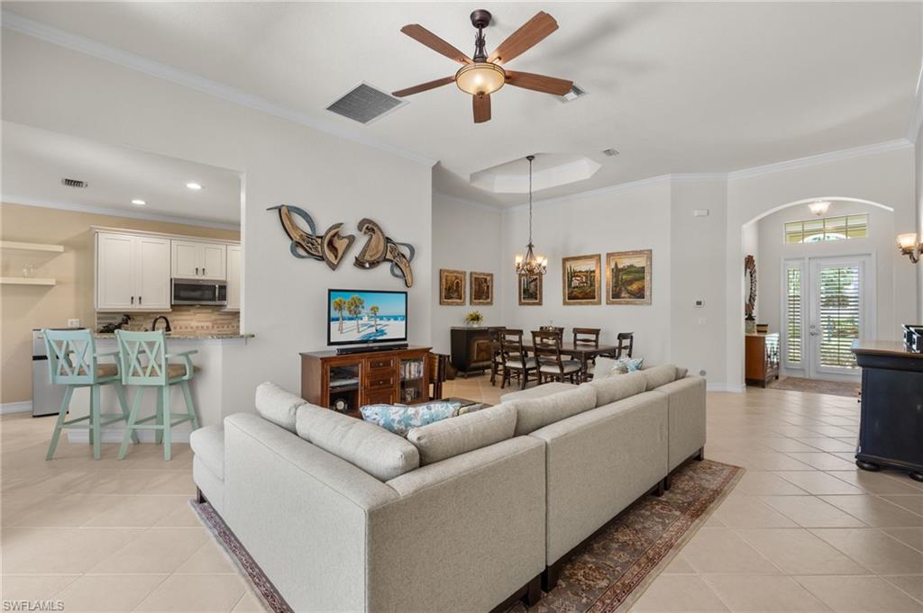 a living room with furniture and a view of kitchen