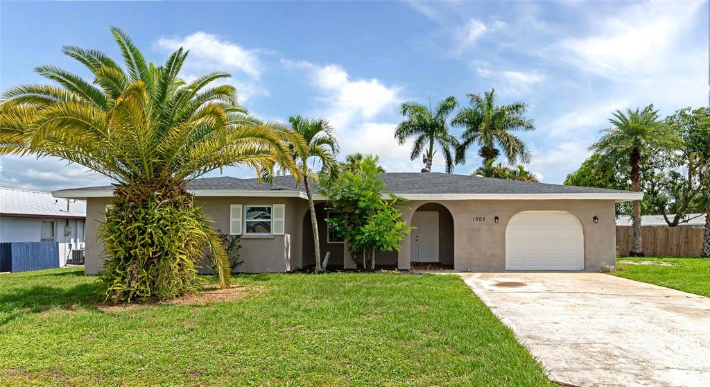 a front view of a house with a garden and yard