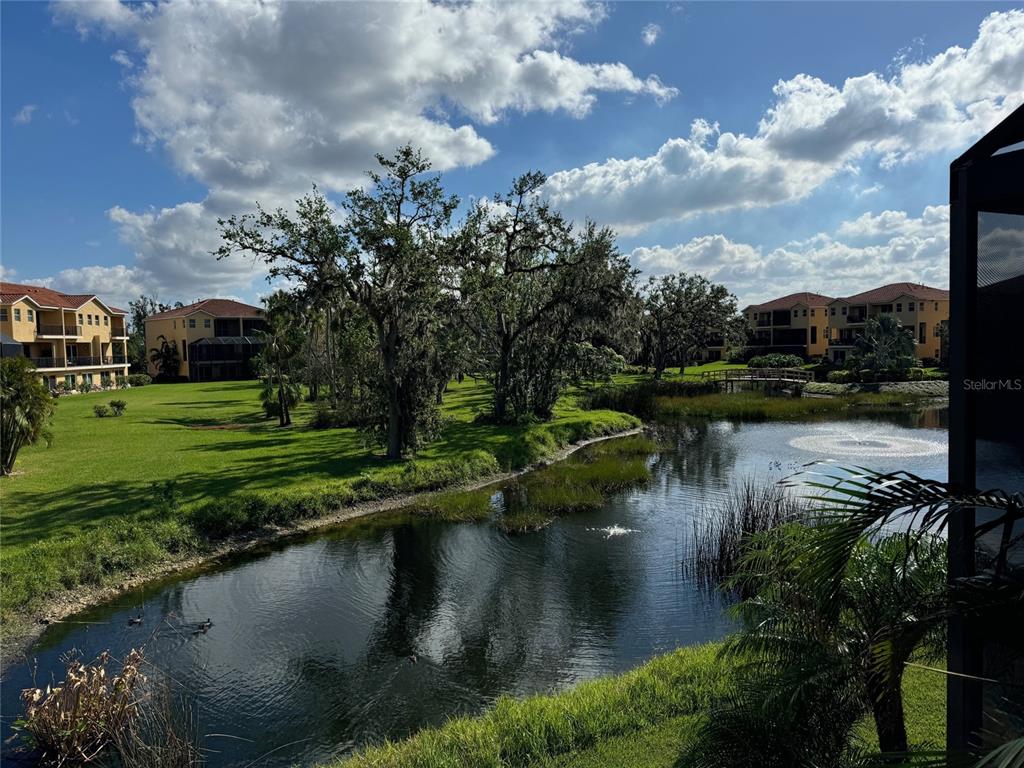 a view of residential house with outdoor space and lake