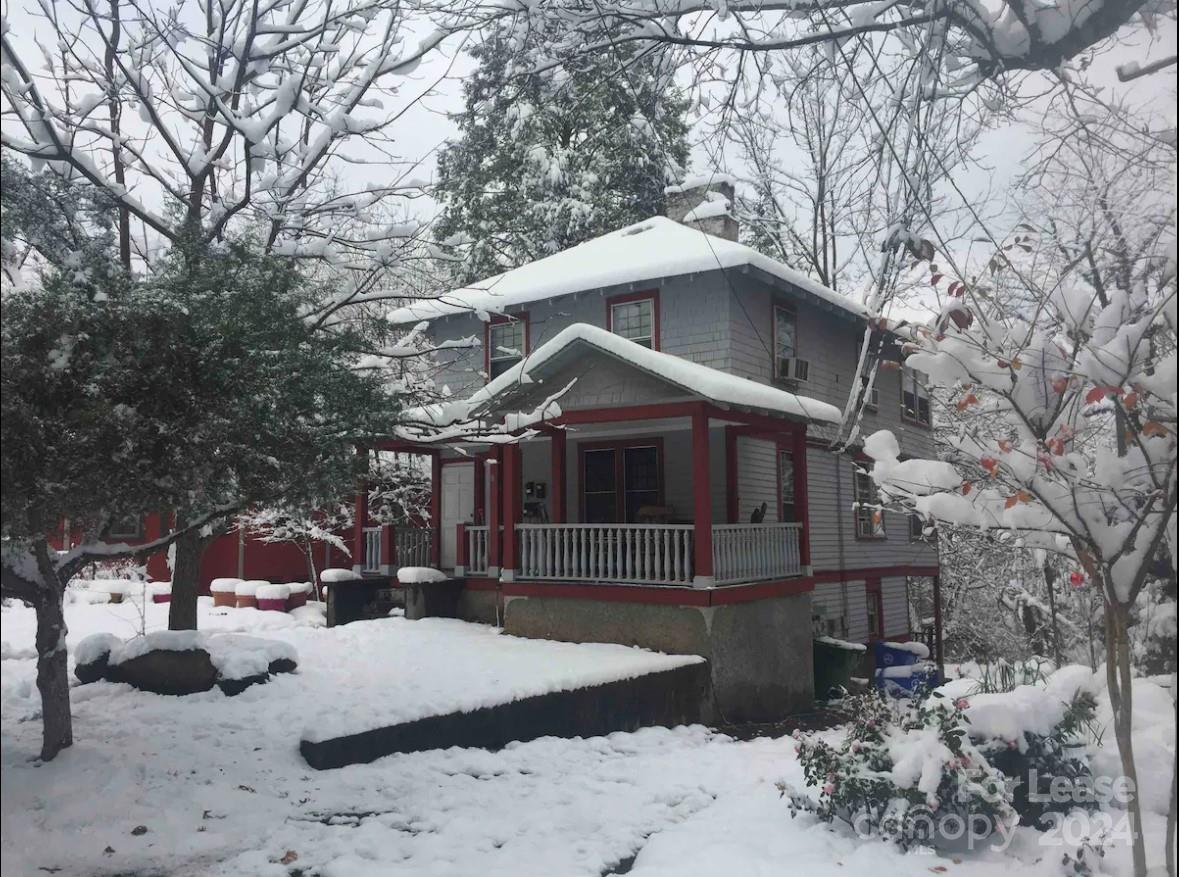 a front view of a house with a yard covered in snow