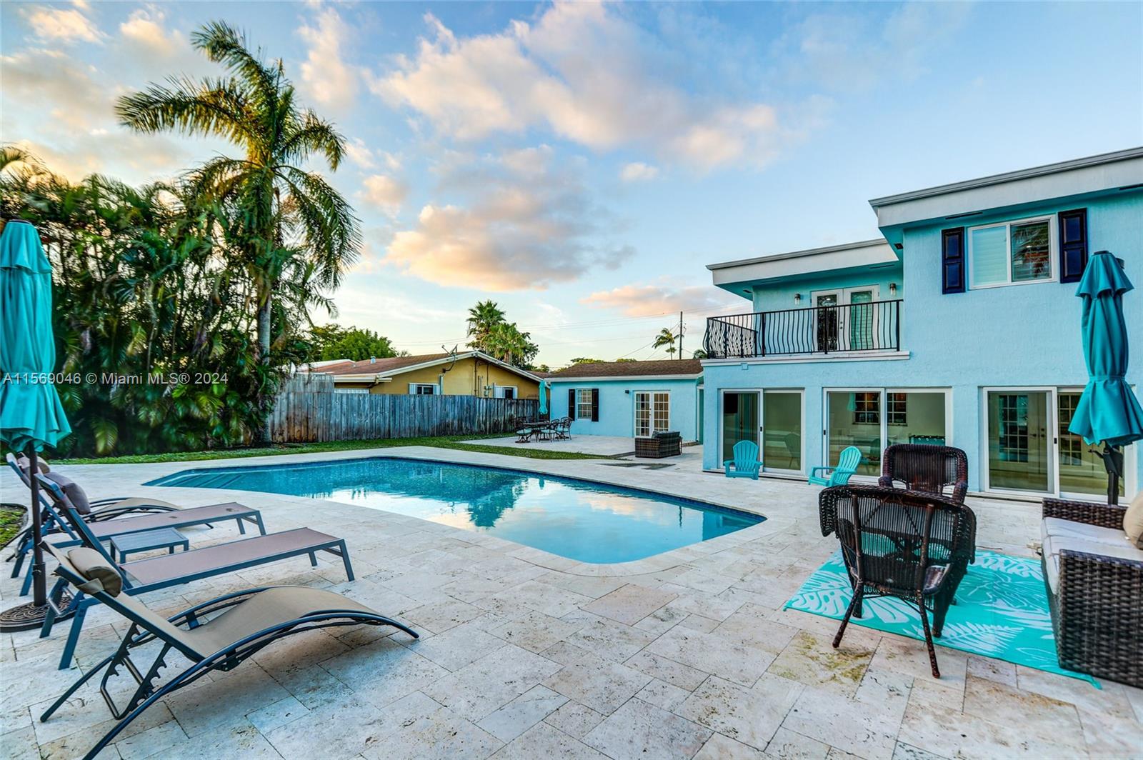 a swimming pool with outdoor seating and yard