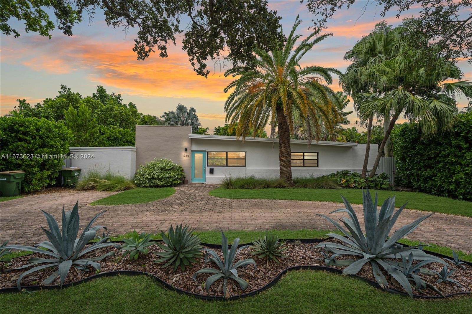 a view of a backyard with plants and a patio