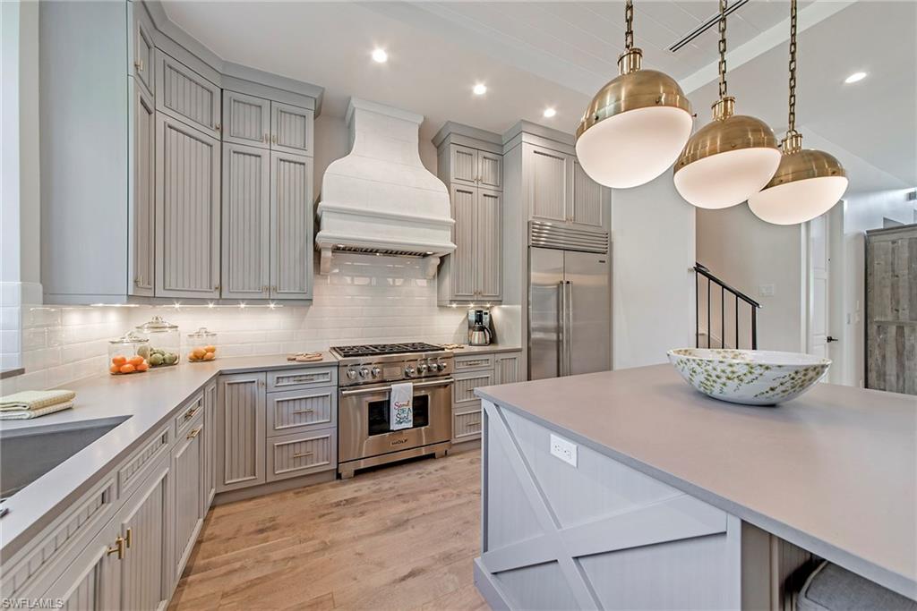 a kitchen with a stove a sink and a refrigerator