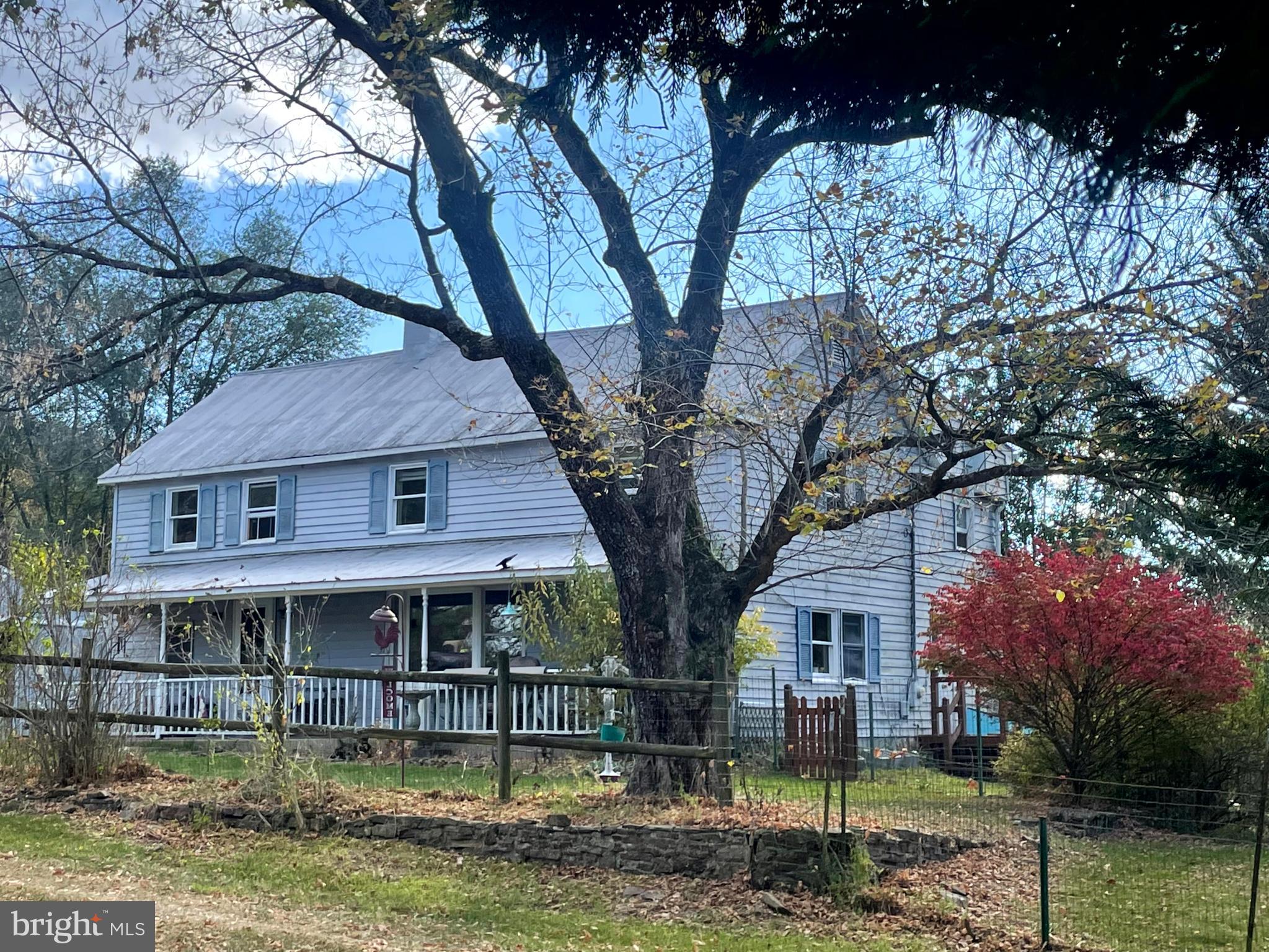 front view of a house with a large tree