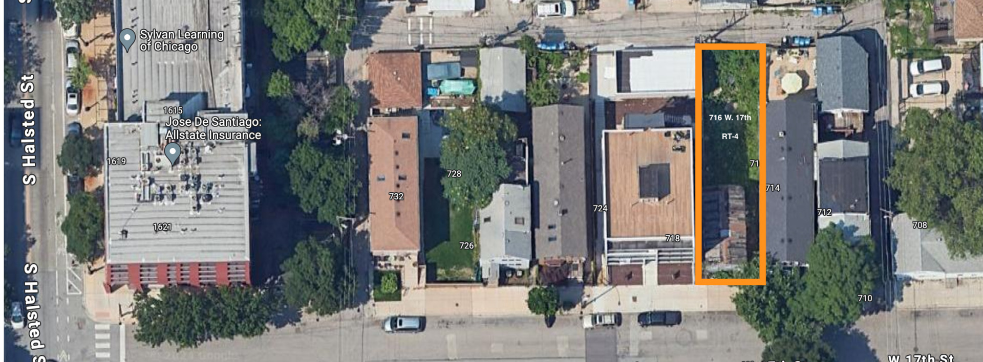 an aerial view of a residential apartment building with a yard and table and chairs potted plants