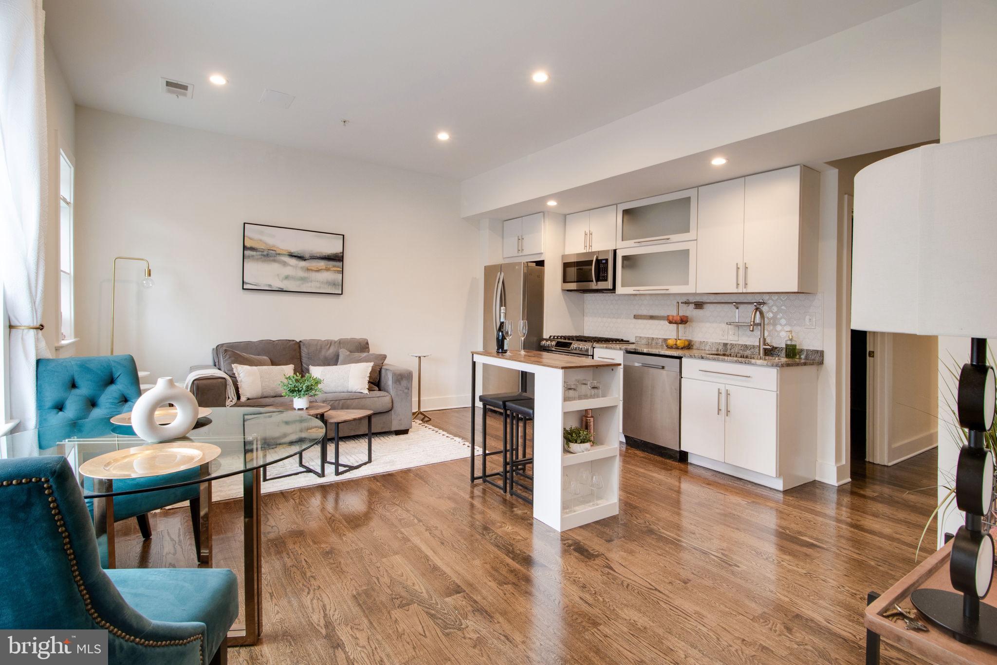 a living room with furniture and kitchen view