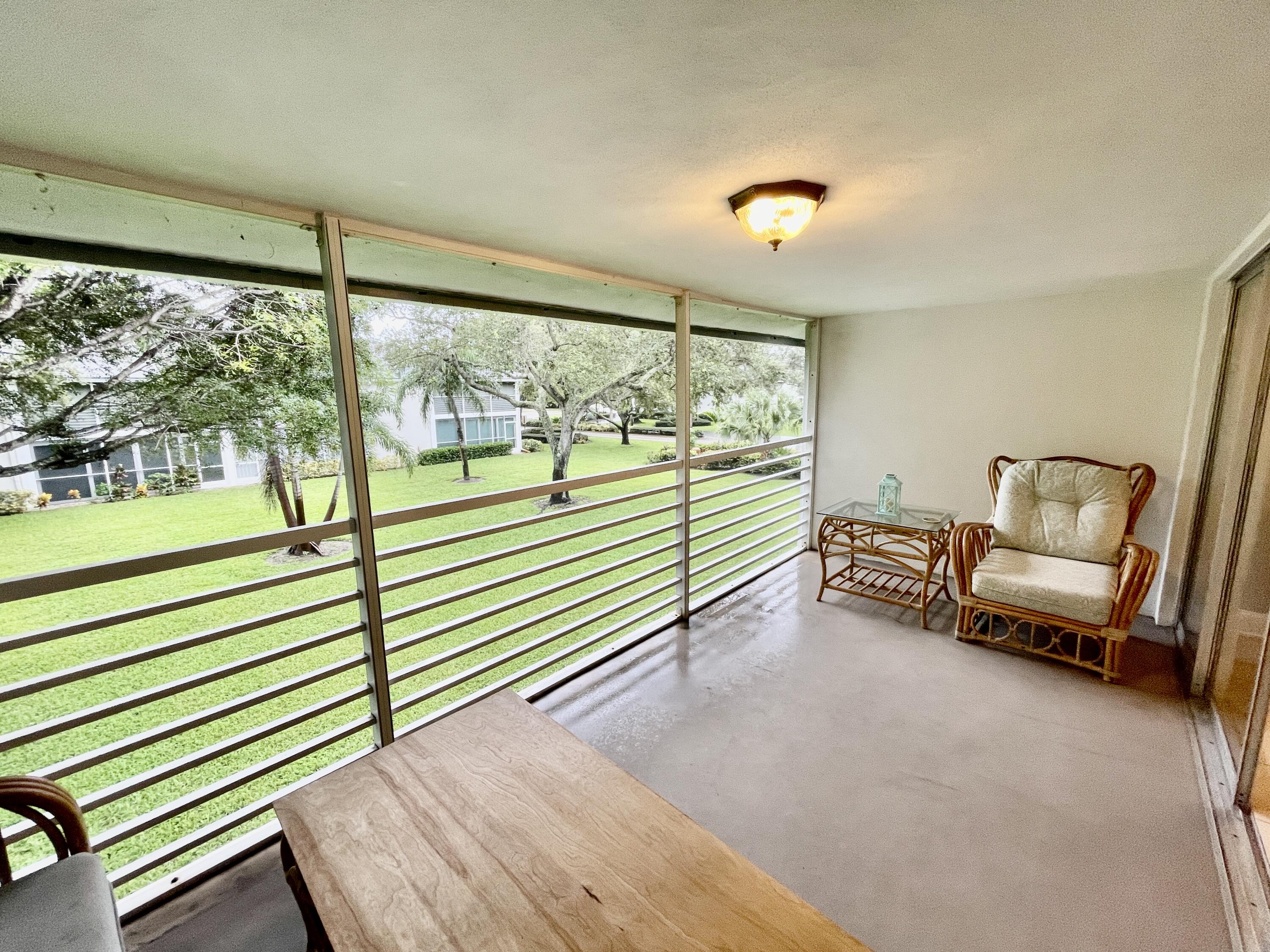 a view of a room with furniture and a large window