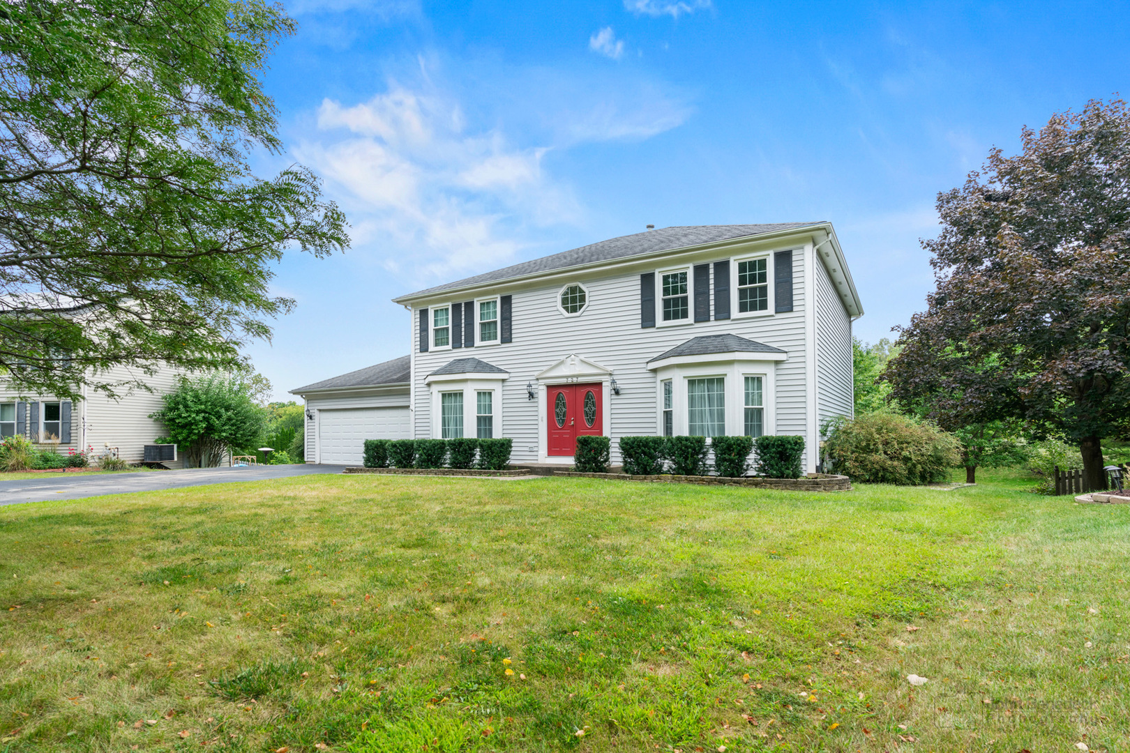 a front view of a house with a garden