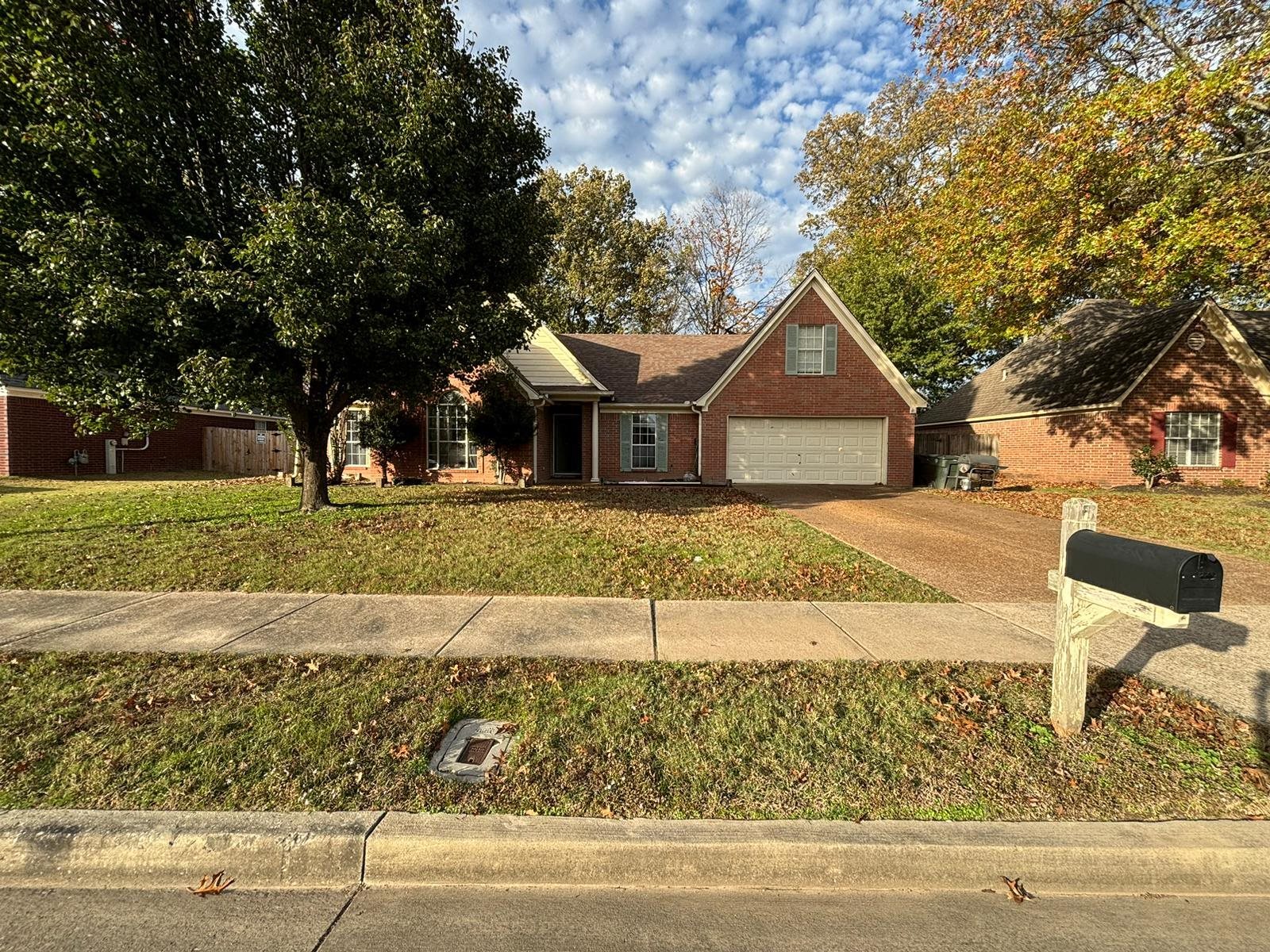 View of front of home with a front lawn and a garage