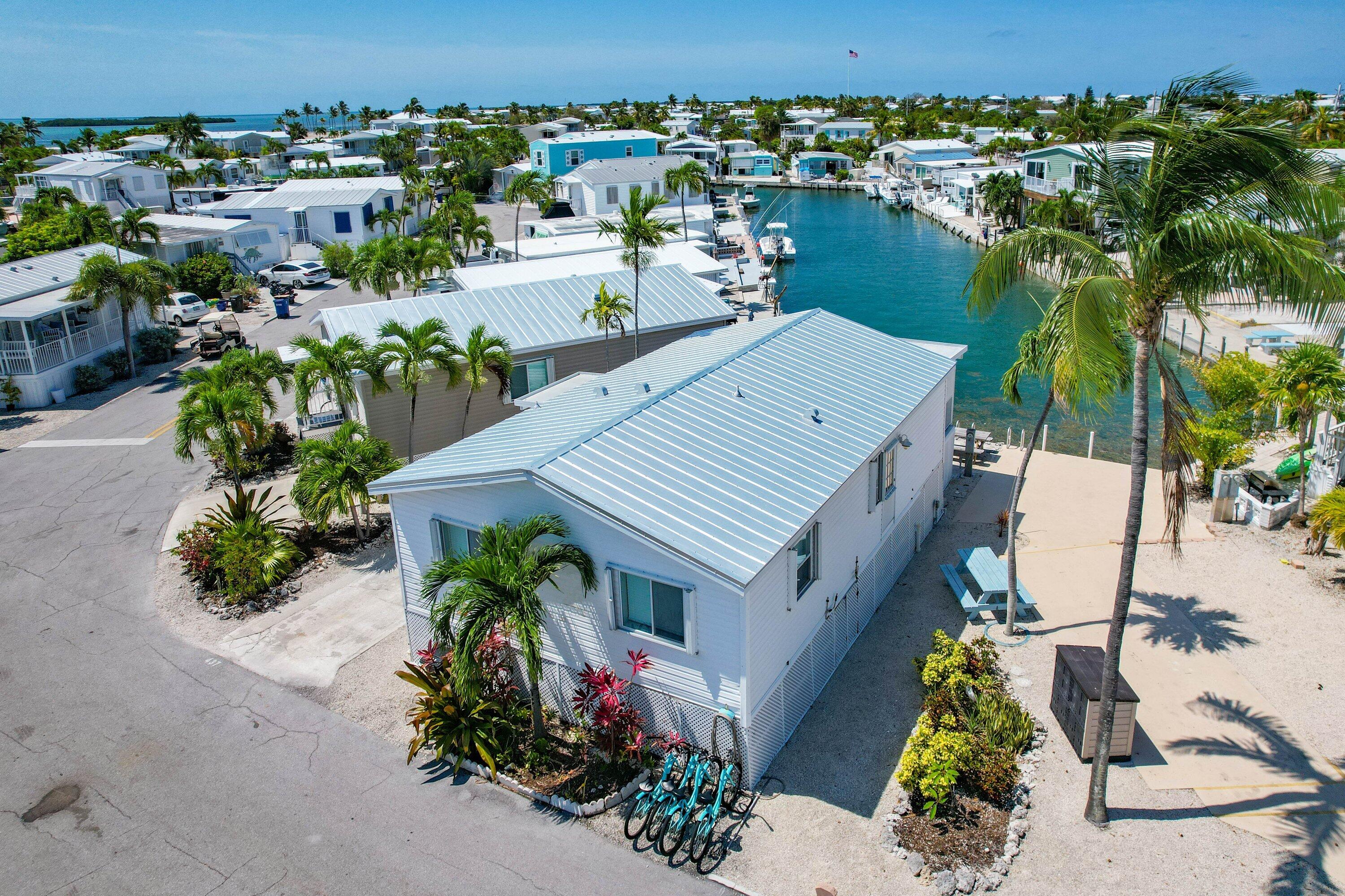 an aerial view of a house with garden space and outdoor seating