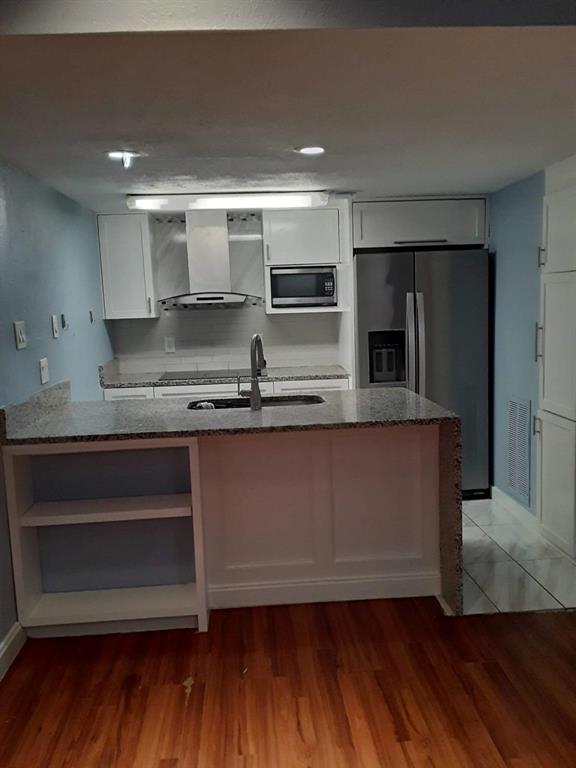 a kitchen with stainless steel appliances granite countertop a sink and a stove top oven