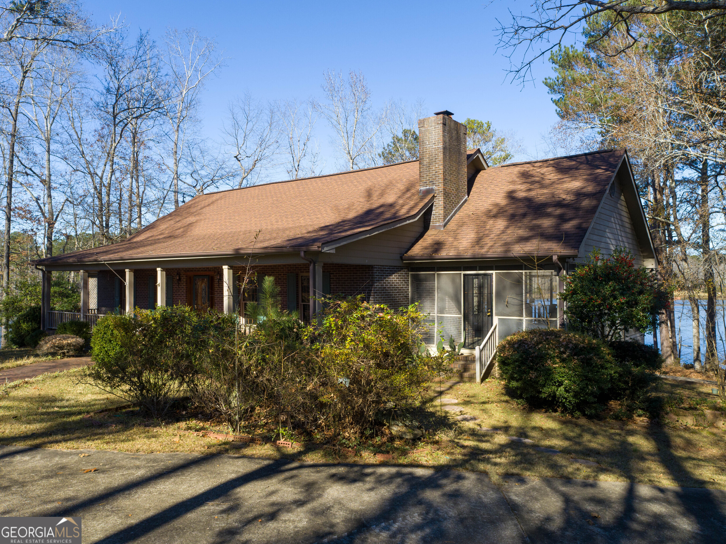 a front view of house with yard space and trees around