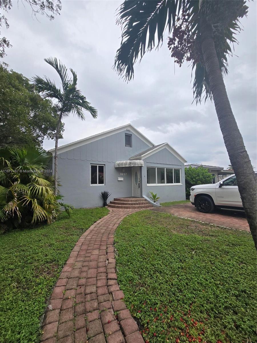 a front view of house with yard and green space