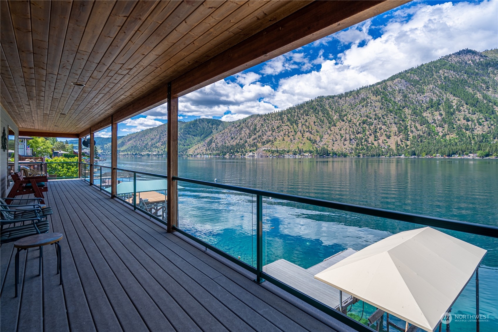 a view of deck with furniture and garden