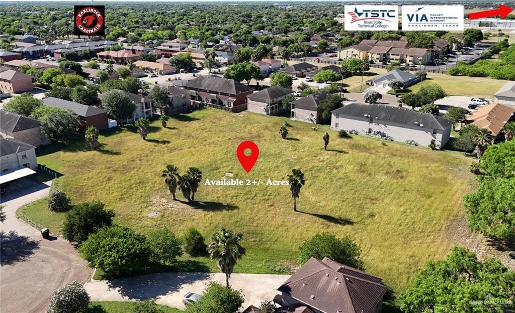 an aerial view of residential houses with outdoor space and swimming pool