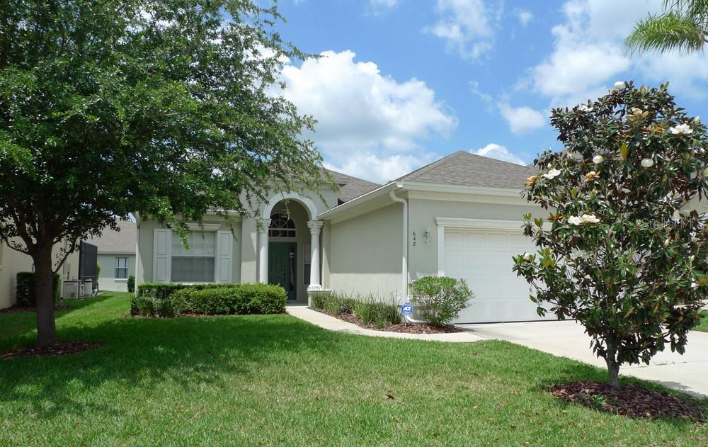 a front view of a house with a garden