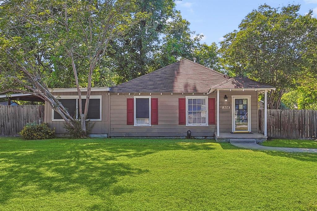 a view of a house with a yard and pathway