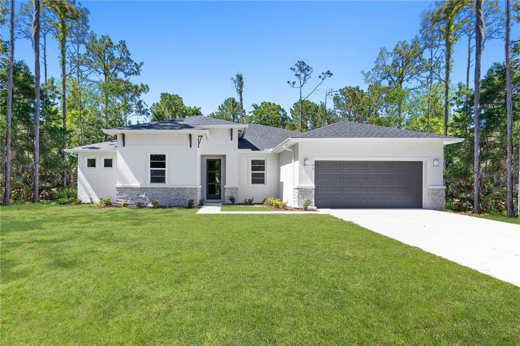 a front view of a house with a yard and garage