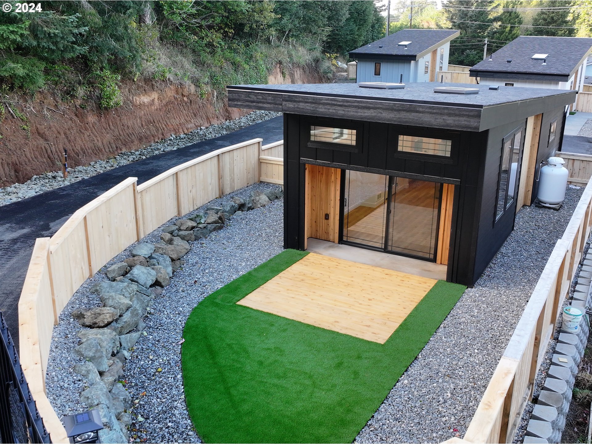 a view of a patio with table and chairs with wooden floor and fence