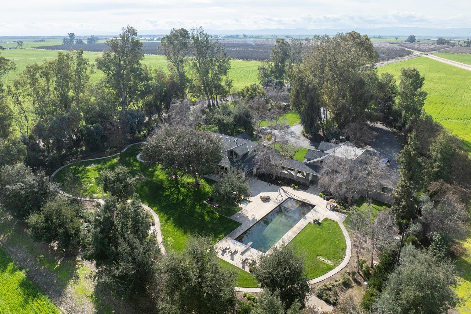 an aerial view of residential house with outdoor space and swimming pool