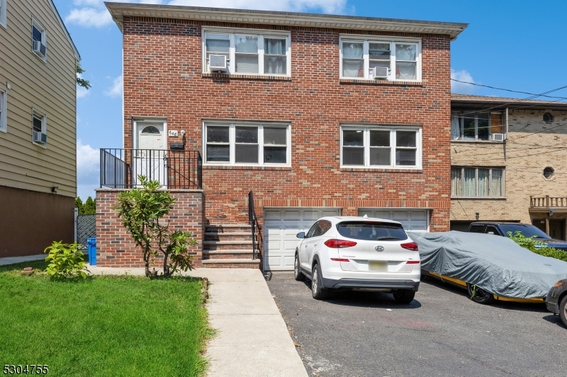 a car parked in front of a brick house