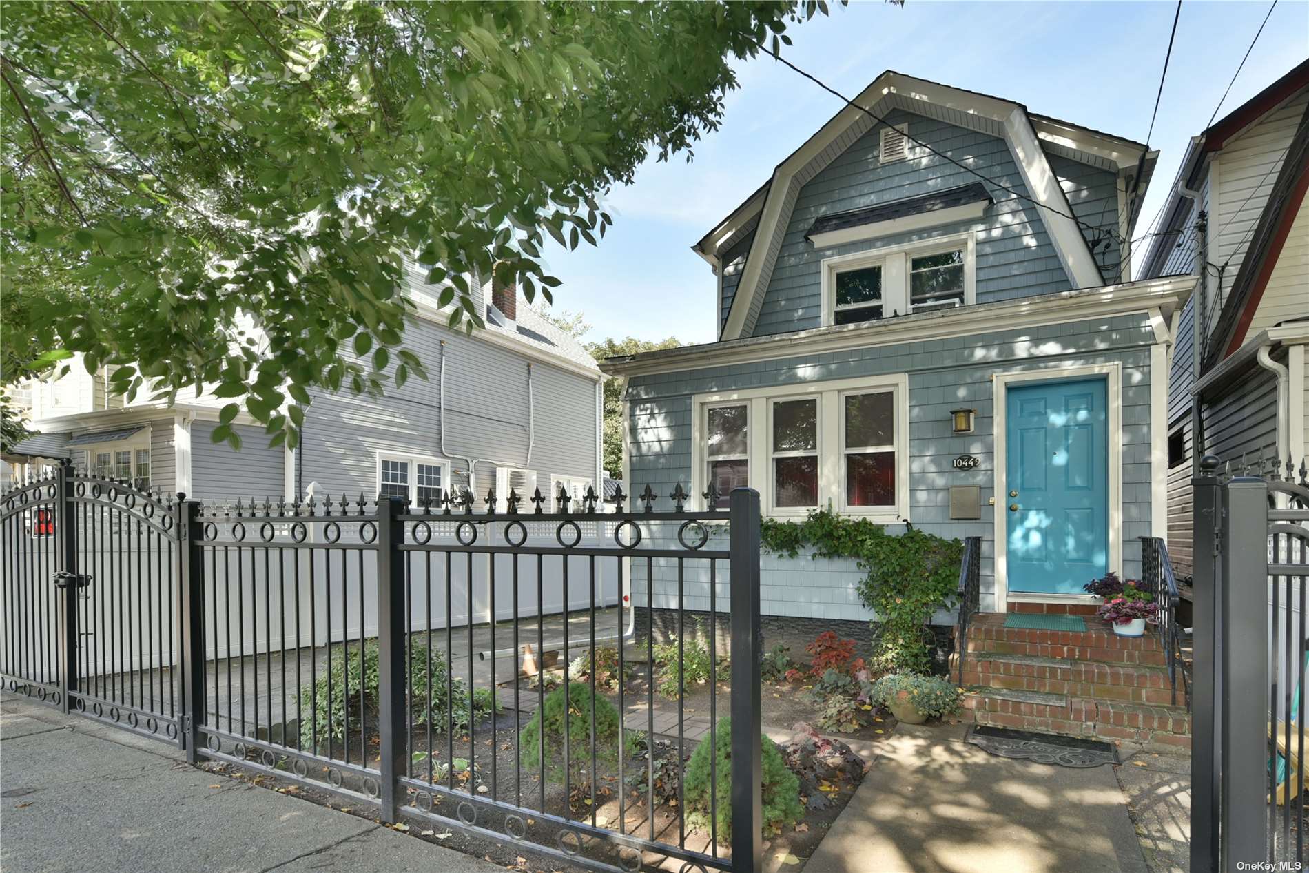 a front view of a house with a garden