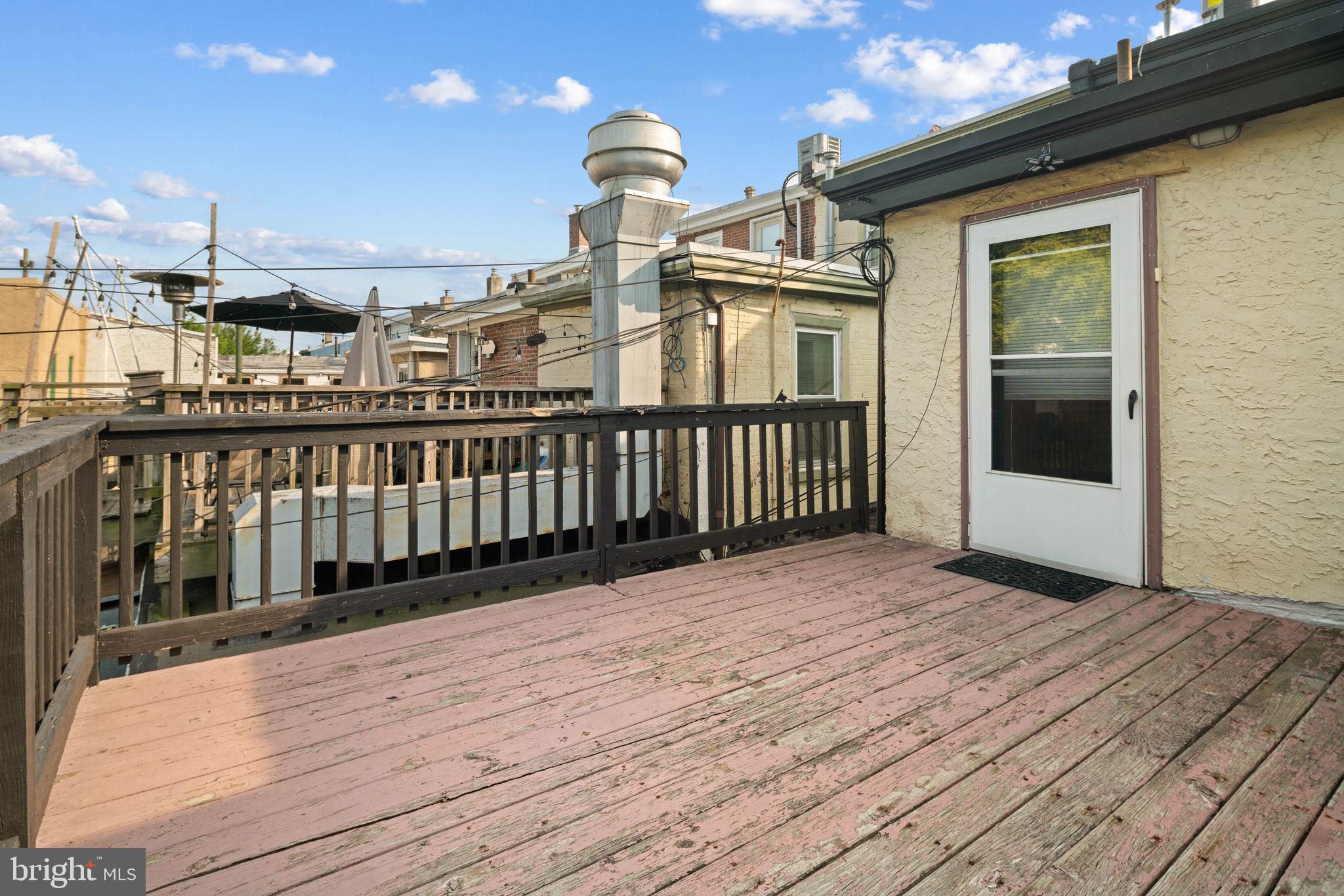 a view of a balcony with wooden floor