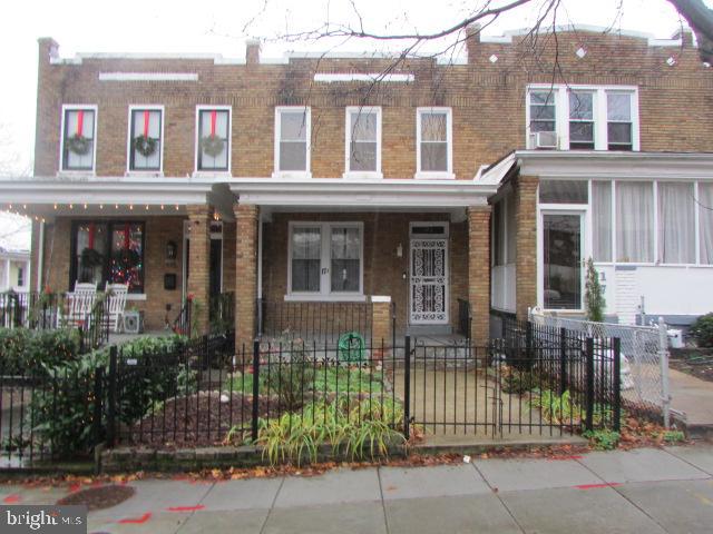 front view of a brick house with a small yard