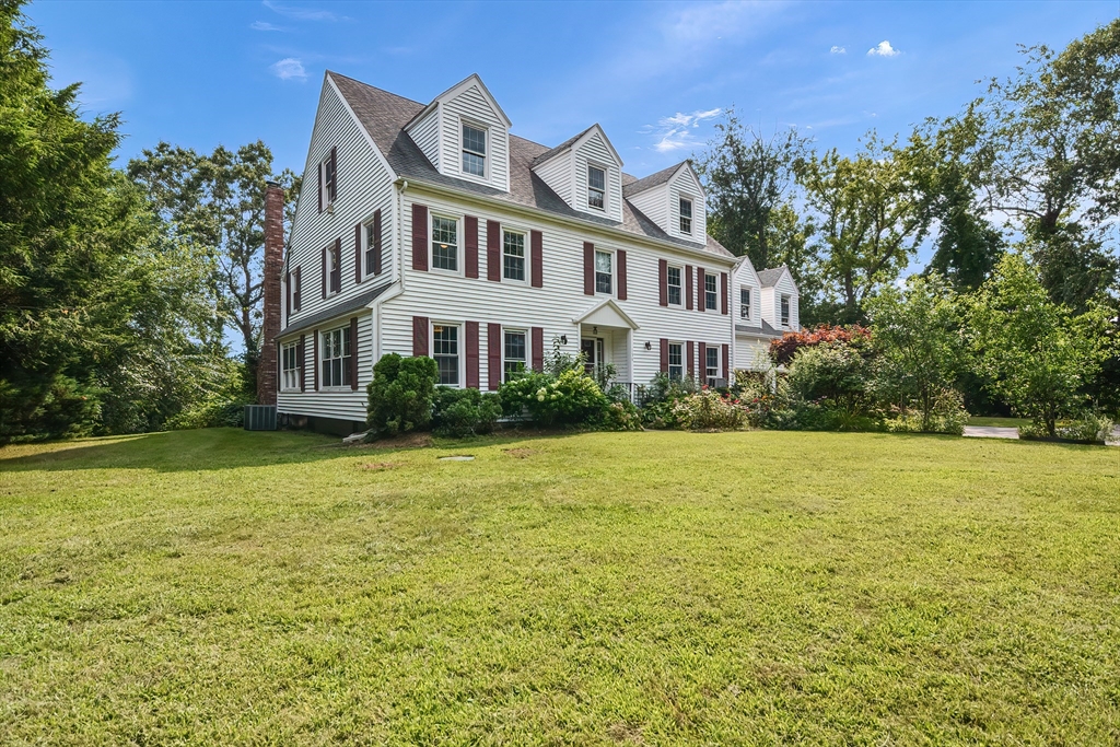 a front view of a house with a garden