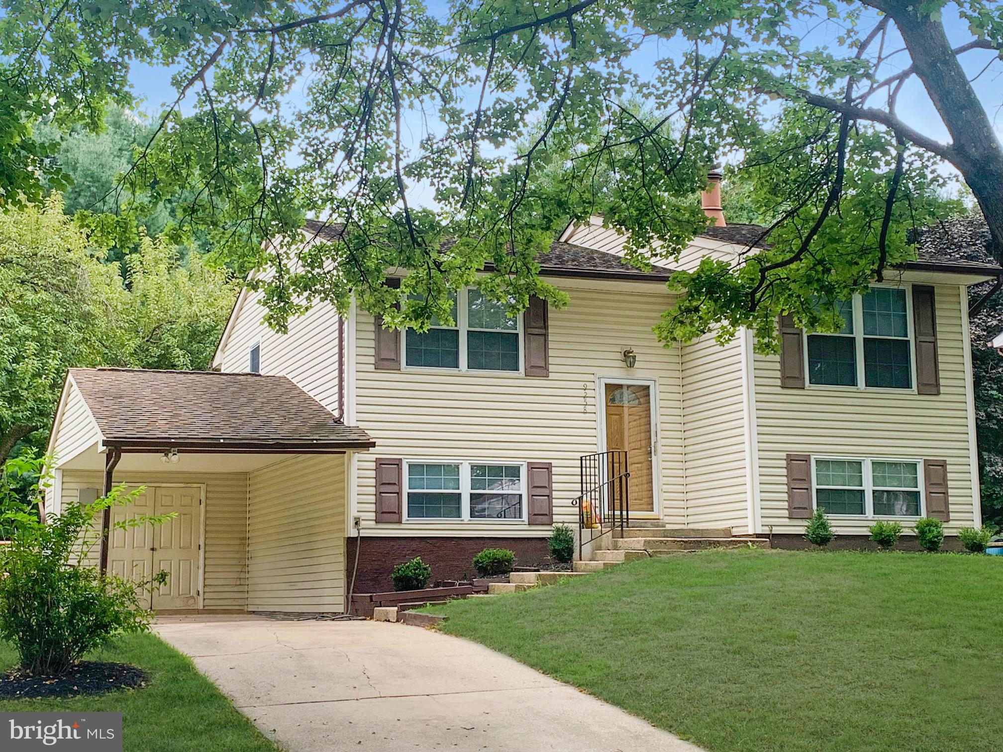 a front view of a house with a garden and yard