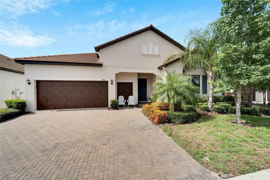 a front view of a house with a yard and garage