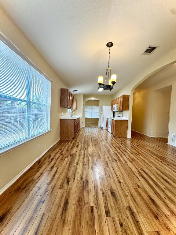 a spacious bedroom with a bed dresser and a window