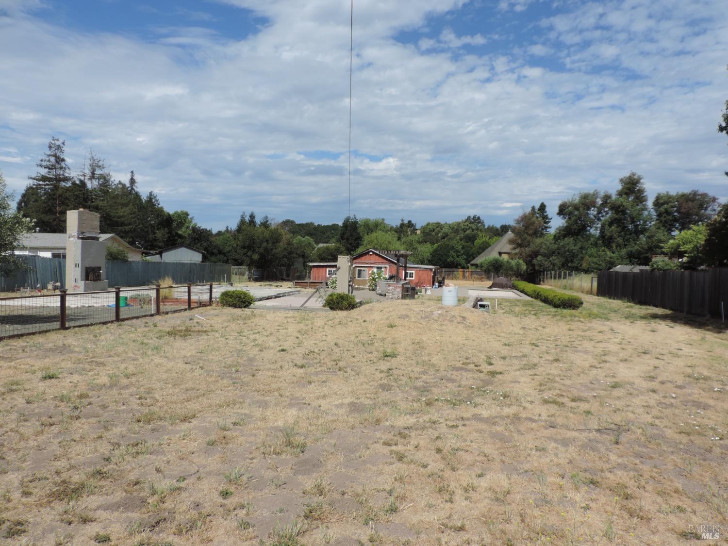 a view of swimming pool with a yard and fence