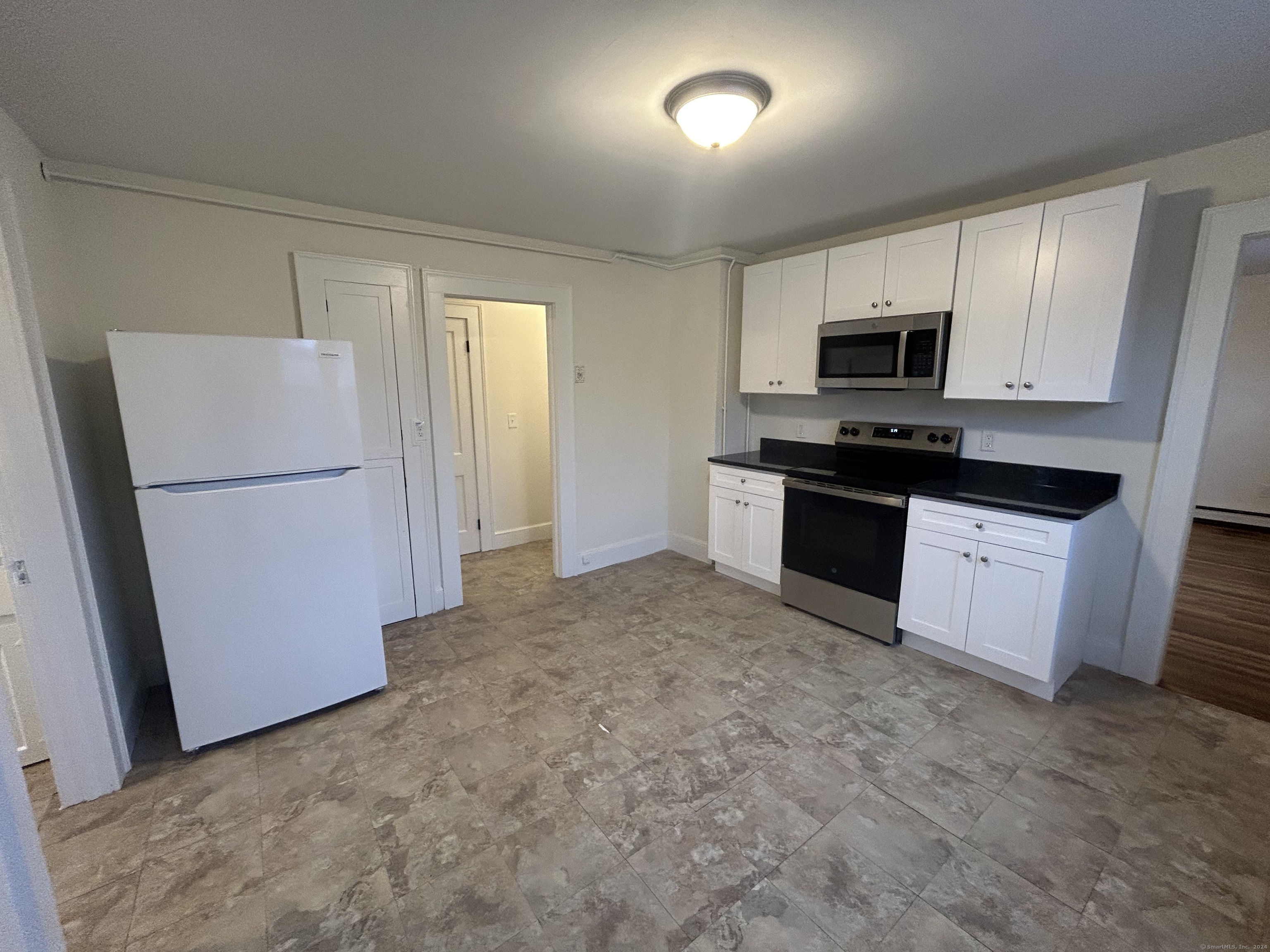 a kitchen with stainless steel appliances a refrigerator stove microwave and sink