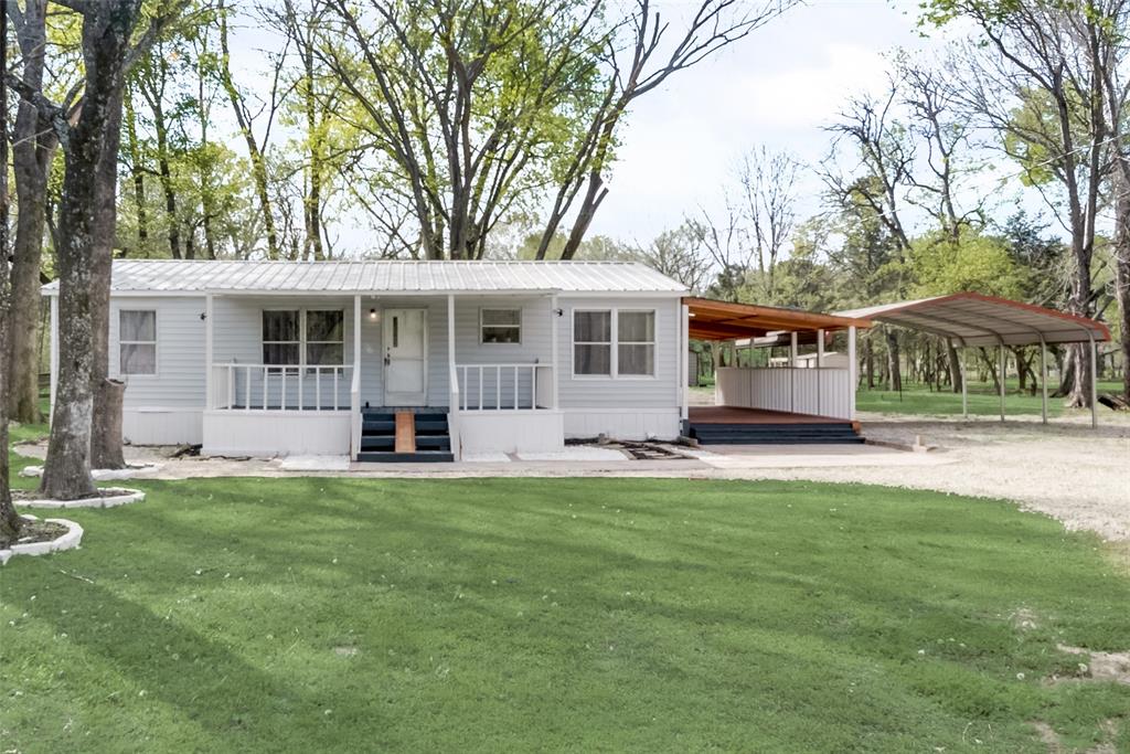 a view of a house with a backyard