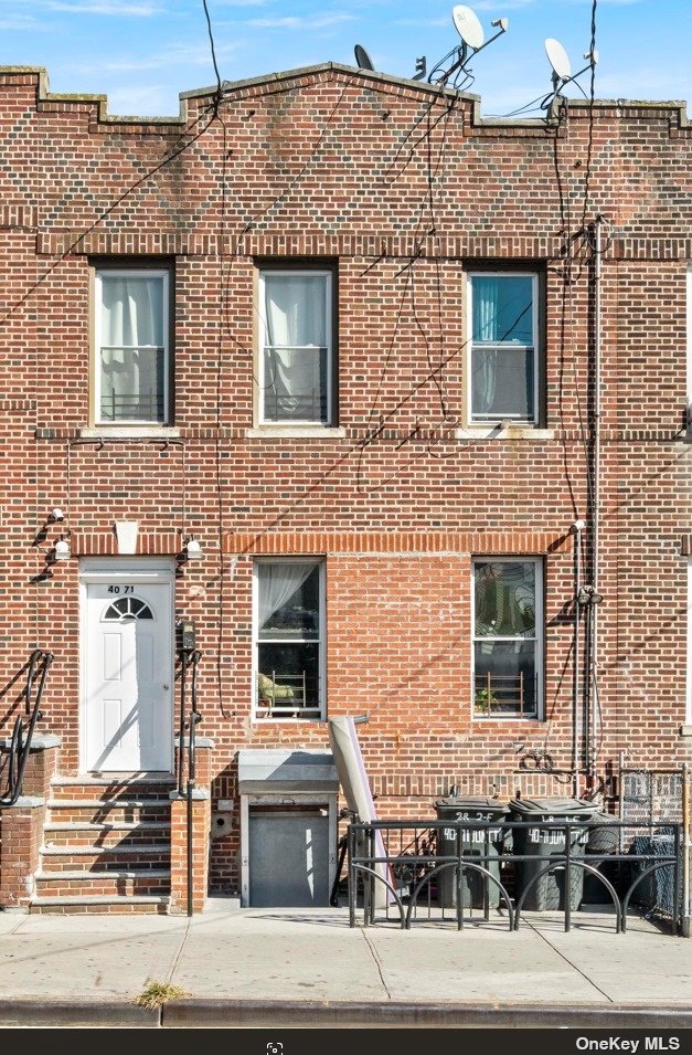 a front view of a house with a brick wall