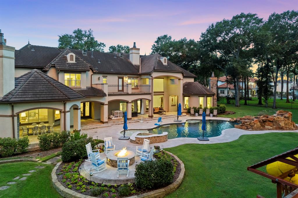 a front view of a house with swimming pool having outdoor seating