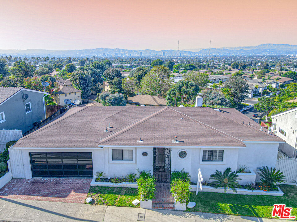 a aerial view of a house next to a yard