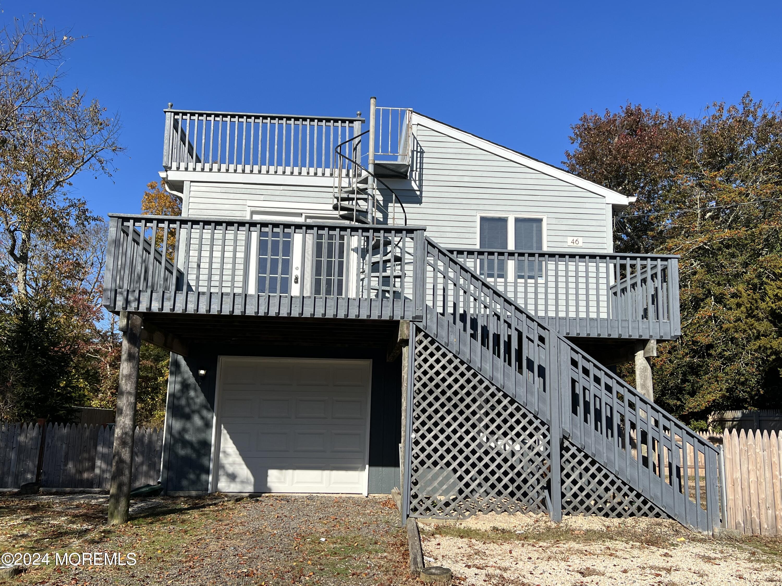 a view of a wooden house with a deck