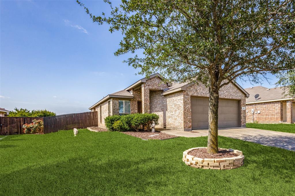 a front view of a house with a yard and green space