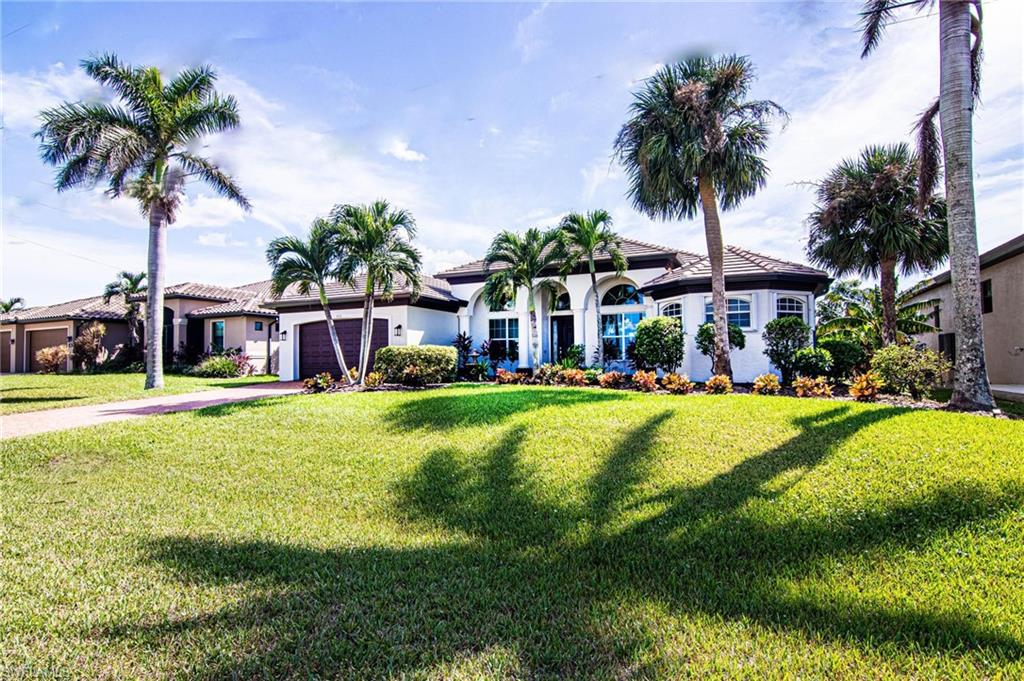 a front view of house with yard and swimming pool