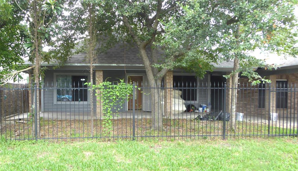 a view of house with a yard and a garden