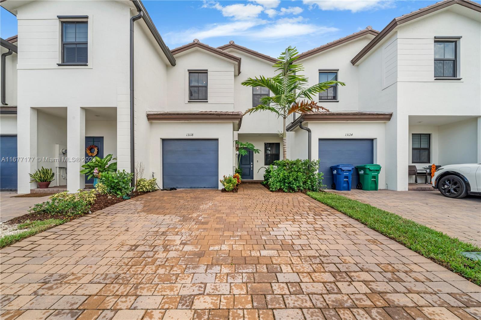 a front view of a house with a yard and a garage