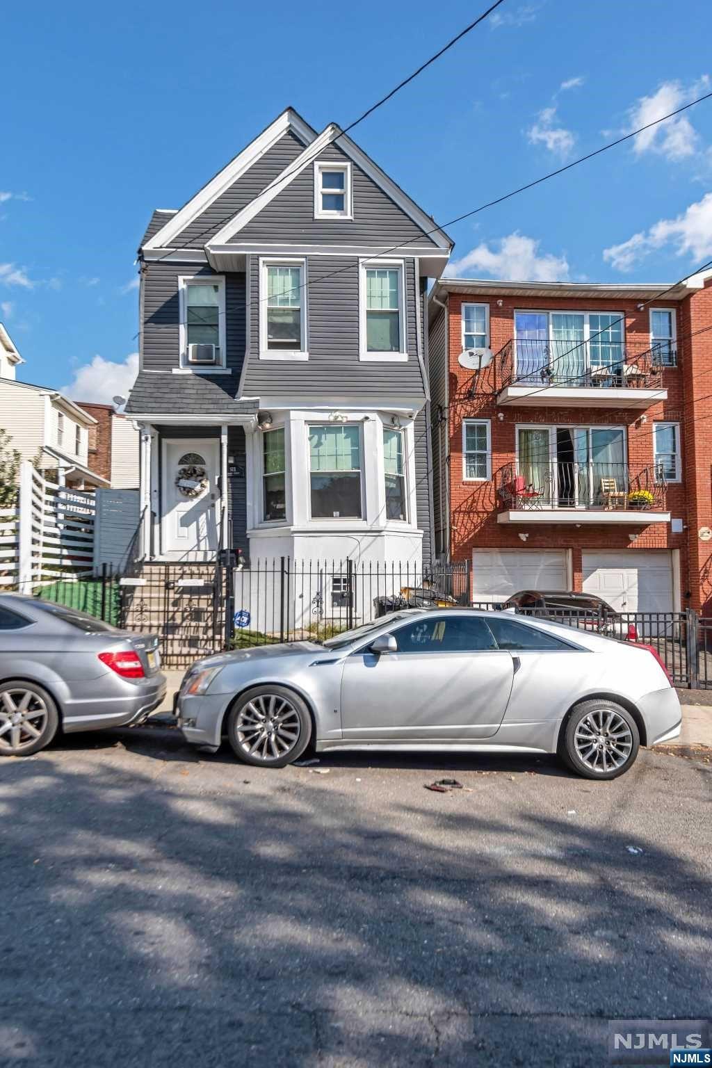 a front view of a house with parking space