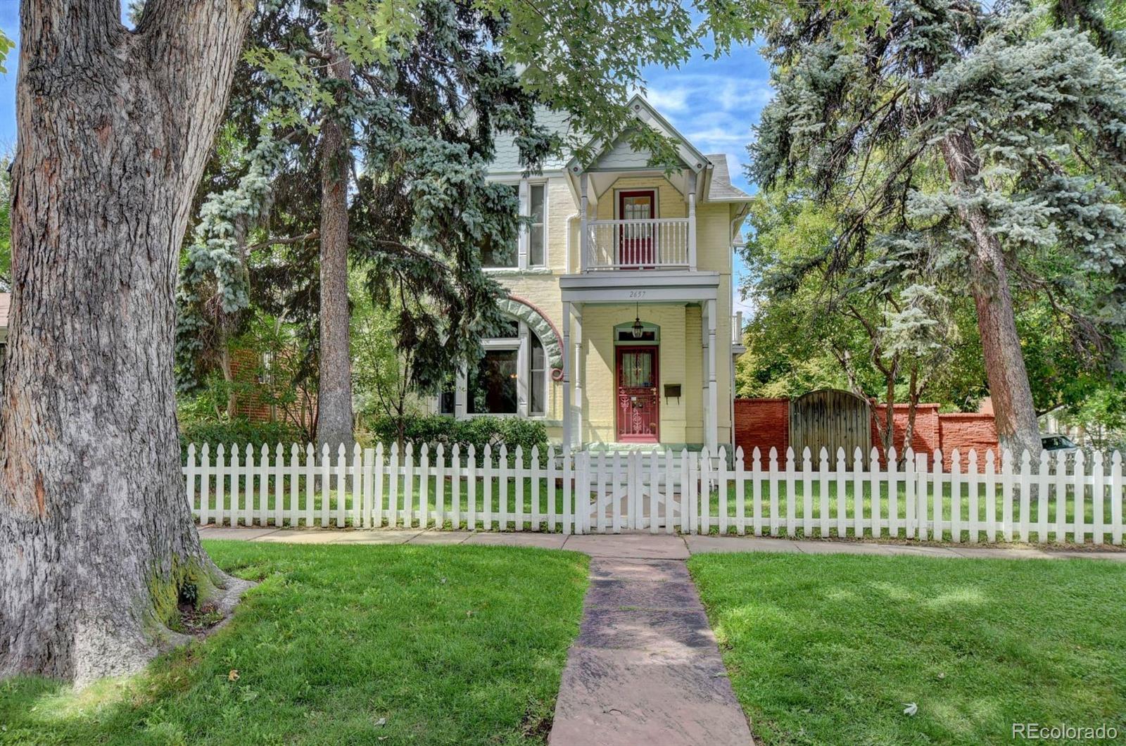 a front view of a house with yard and deck