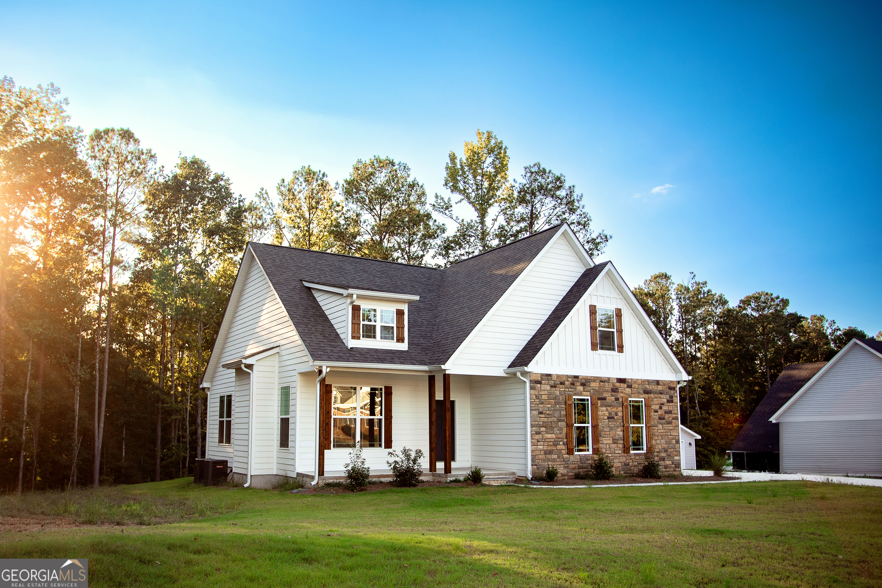 a front view of a house with a garden and plants