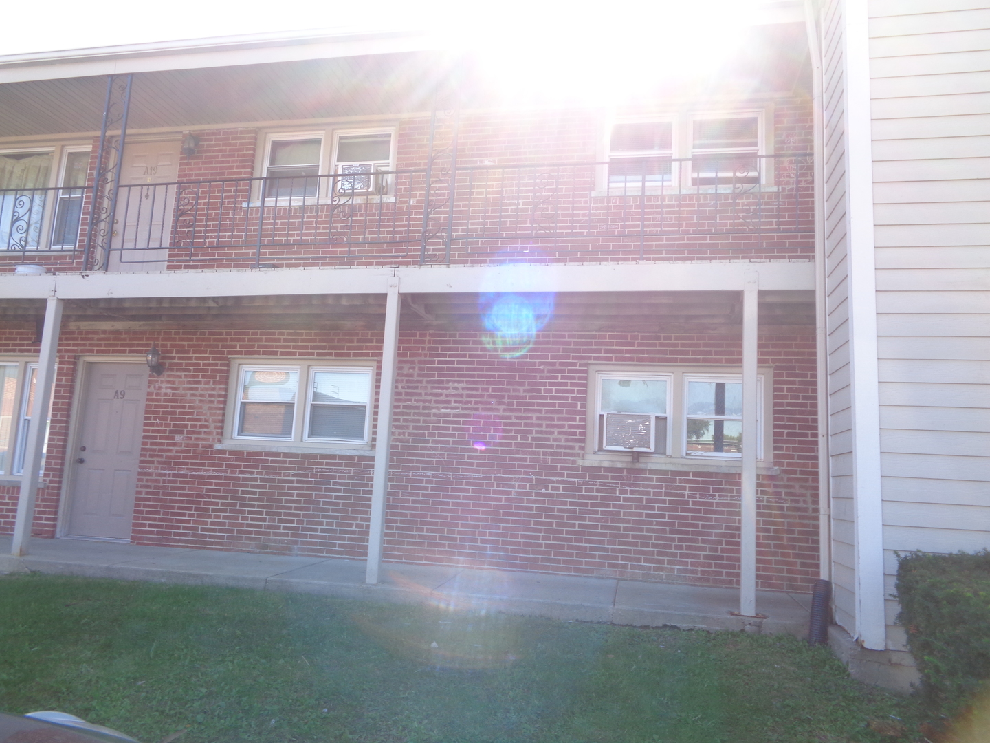 a view of a brick building next to a yard