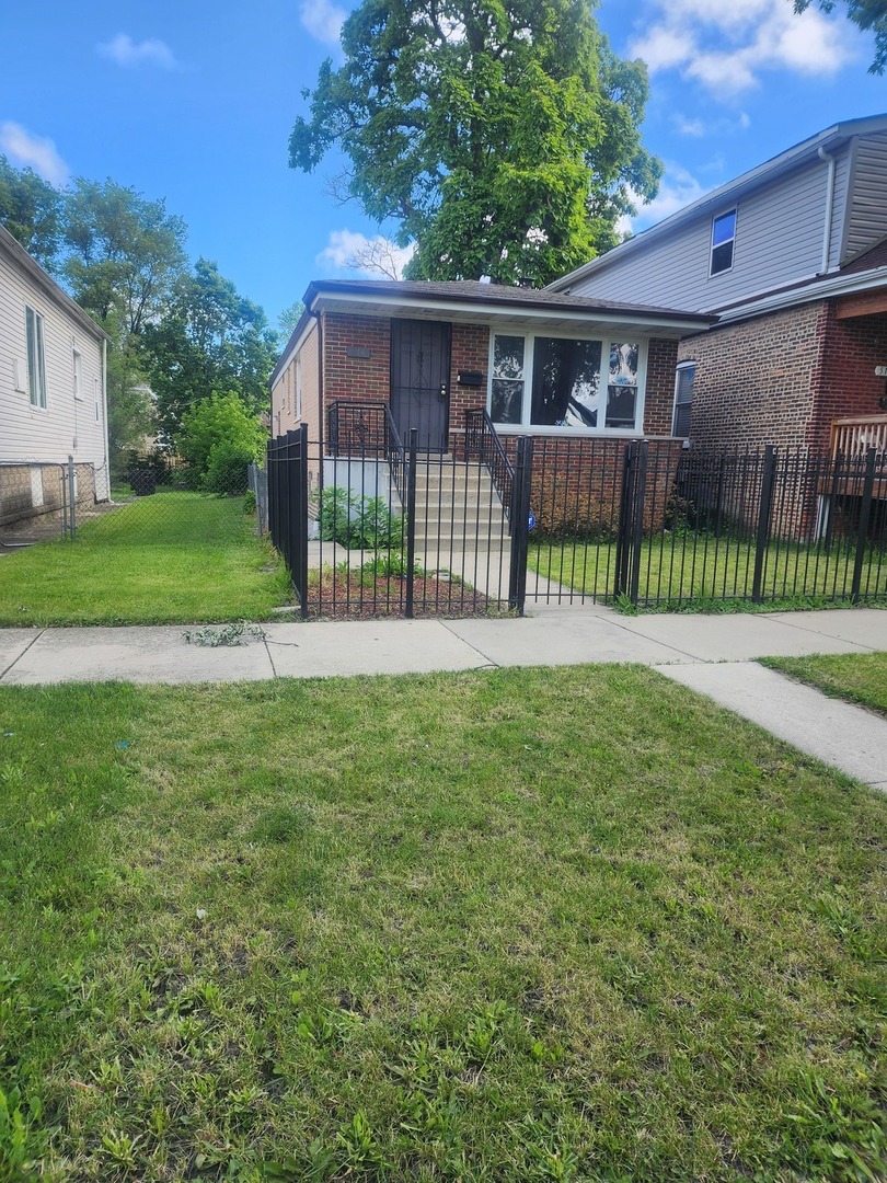 a view of a house with a yard and a garden