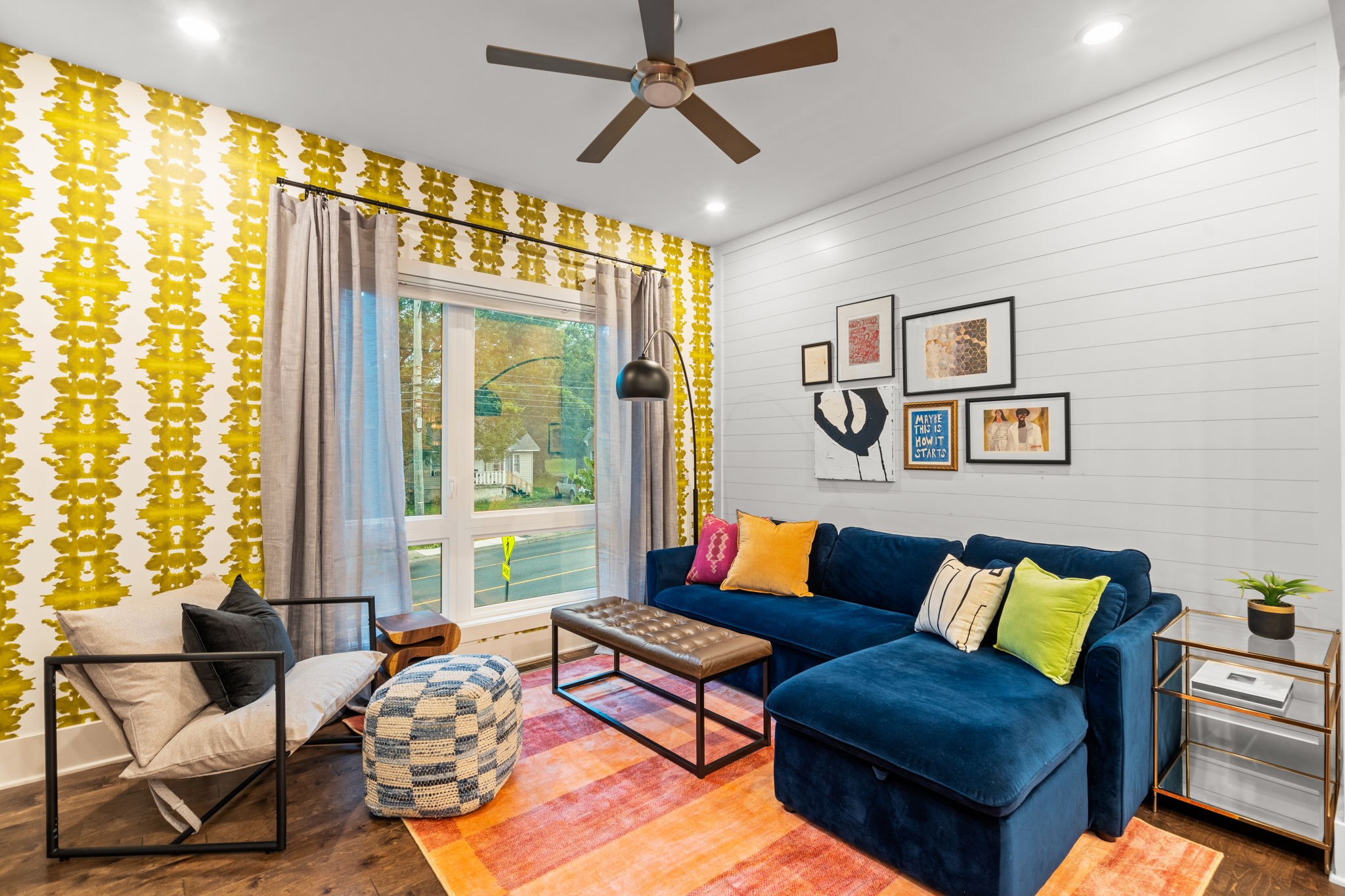 a living room with furniture and a large window